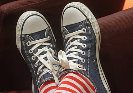 Person Wearing a Pair of Blue Low-top Sneakers thumbnail