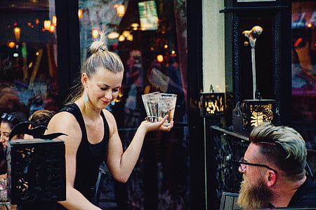 Woman Holding Higball Glass in Front of Man thumbnail