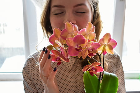 woman smelling orchids thumbnail