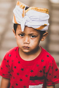 Boy Wearing Red and Black Star Print Crew-neck T-shirt Selective Focus Photography thumbnail