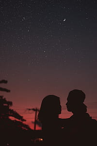 silhouette of couple hugging under starry night thumbnail