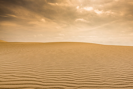 desert under brown clouds during daytime thumbnail
