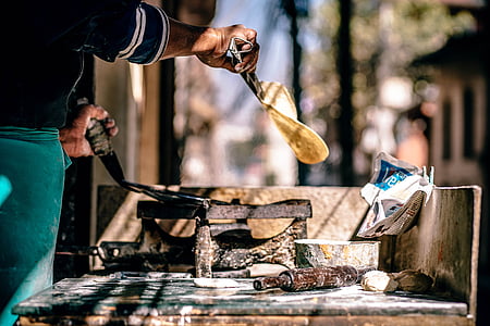 person holding brown hand tool thumbnail