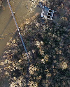 aerial photography of body of water with bridge surrounded with tree thumbnail