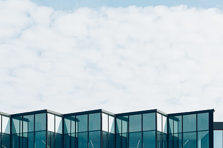 blue glass building under clear sky thumbnail