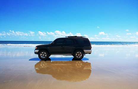 black SUV on seashore thumbnail