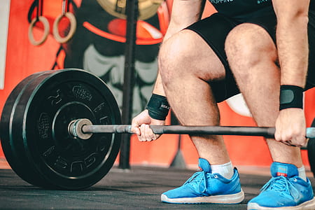 person lifting black barbell thumbnail