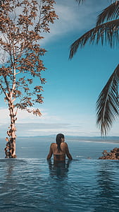 woman looking at the ocean in infinity pool thumbnail