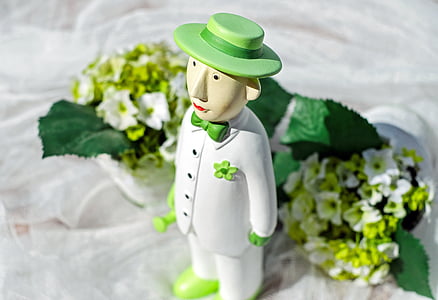male character wearing white button-up jacket figurine near white petaled flower bouquet thumbnail