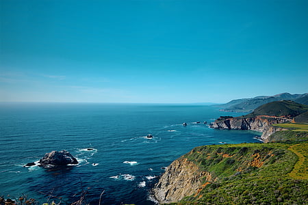 aerial photography of mountain cliff near water thumbnail