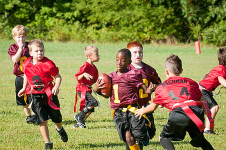 group of boys playing American football thumbnail