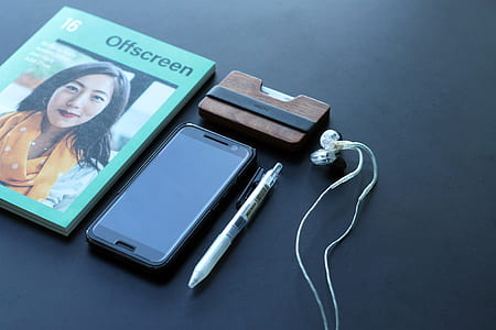 OFF SCreen case beside black Android smartphone and click pen on black surface thumbnail