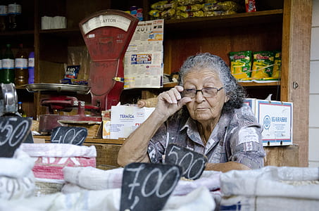 woman holding eyeglasses in front of sack thumbnail