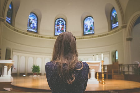 woman facing stage inside dome building thumbnail