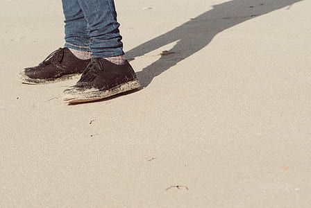 person wearing black low-top sneakers thumbnail