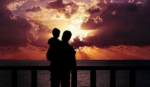 silhouette of man holding toddler during golden time thumbnail