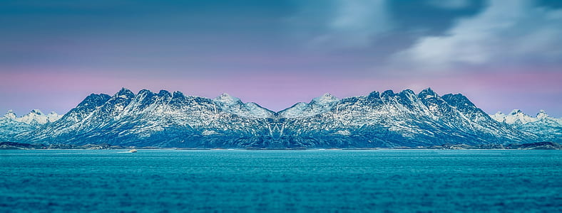 body of water surrounded by rock formation thumbnail