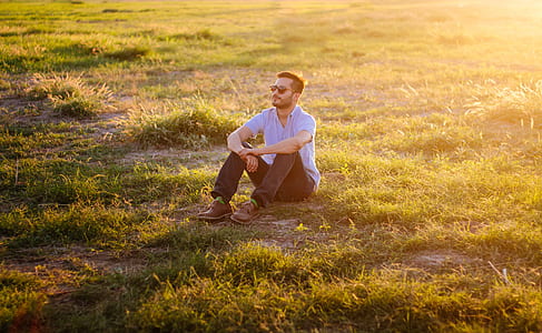 man sitting on green grass thumbnail