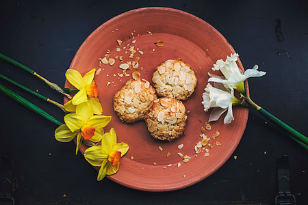 yellow and white petaled flowers near bowl of food thumbnail