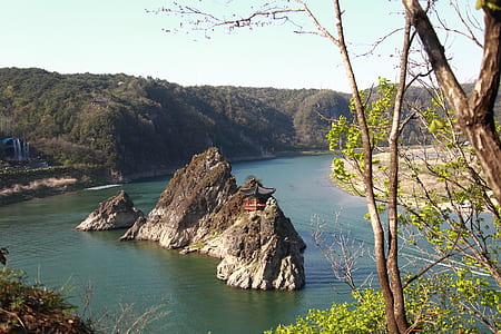 aerial photography of brown outcrop on body of water thumbnail