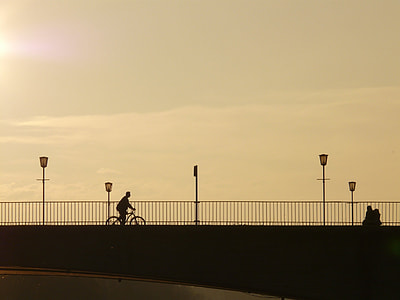 person riding bicycle near street light thumbnail