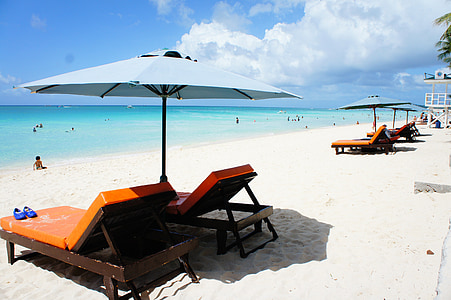 several sun lounger beside shoreline thumbnail