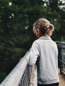 woman looking down leaning on railing thumbnail