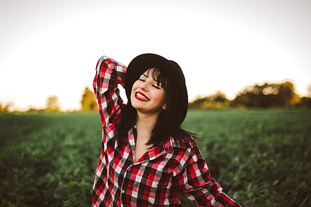 woman wearing red and black flannel during daytime thumbnail