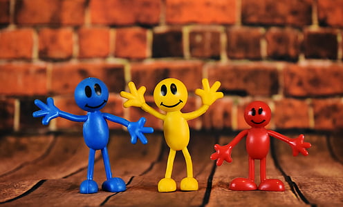 three blue, yellow, and red plastic smiley emoji toys thumbnail