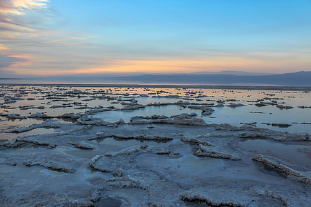 rock formation surrounded with water under clear sky during daytime thumbnail