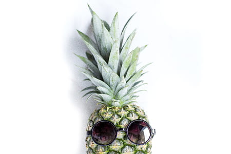 pineapple with black sunglasses on white surface thumbnail