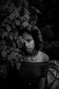 woman in selective focus photography near leaves thumbnail