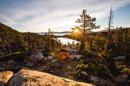 orange camping tent on mountain during sunrise thumbnail
