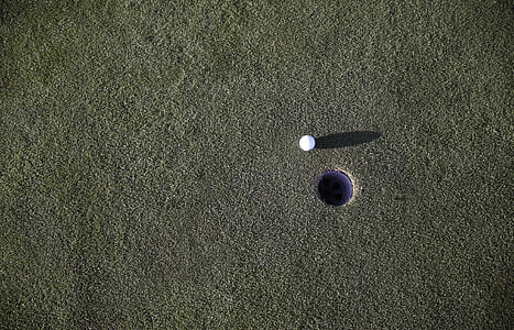 golf ball and hole at daytime thumbnail
