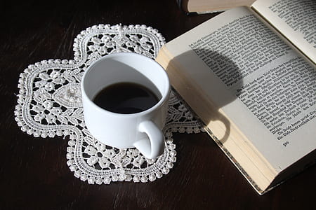 white teacup beside book thumbnail
