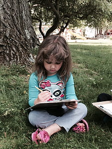 girl writing the under tree thumbnail