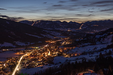aerial photography of town between mountain during nighttime thumbnail