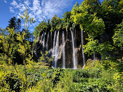 time lapse photography of water falls under white sky thumbnail