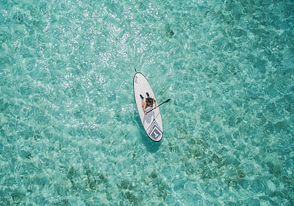 bird's-eye photography of person riding paddleboard thumbnail