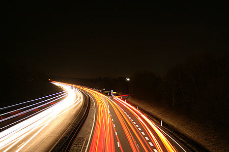 timelapse photography of cars passing on highway during night time thumbnail
