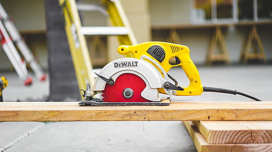 shallow focus photography of DEWALT circular saw on top of plank thumbnail