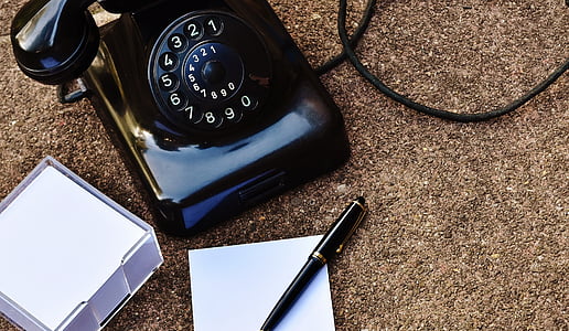 black rotary phone near pen thumbnail