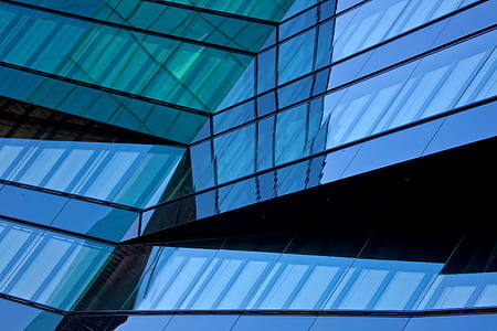 black, blue, and green glass building closeup photo thumbnail