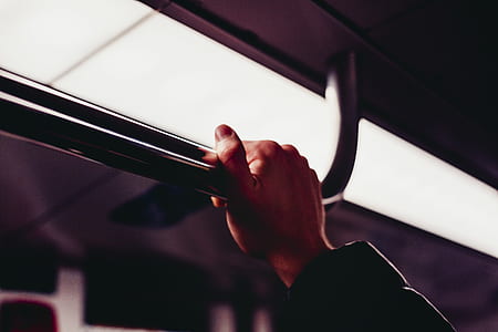 Human's Hand Holding on Silver Handle Bar Photography thumbnail