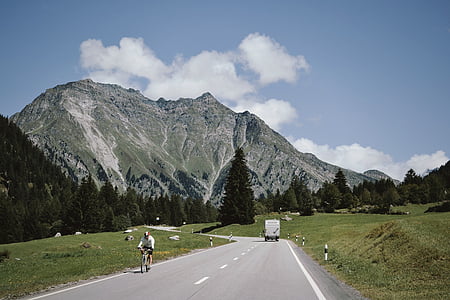 white box truck on road near mountain during daytime thumbnail
