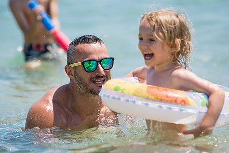 man wearing black sunglasses holding girl thumbnail