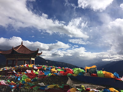 white temple with lots of assorted-color flags thumbnail