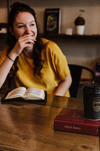 woman sitting in front of the book on desk thumbnail