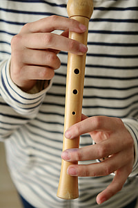 person playing wooden flute thumbnail