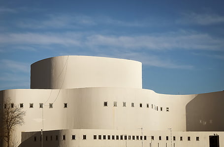 gray concrete building under blue sky thumbnail